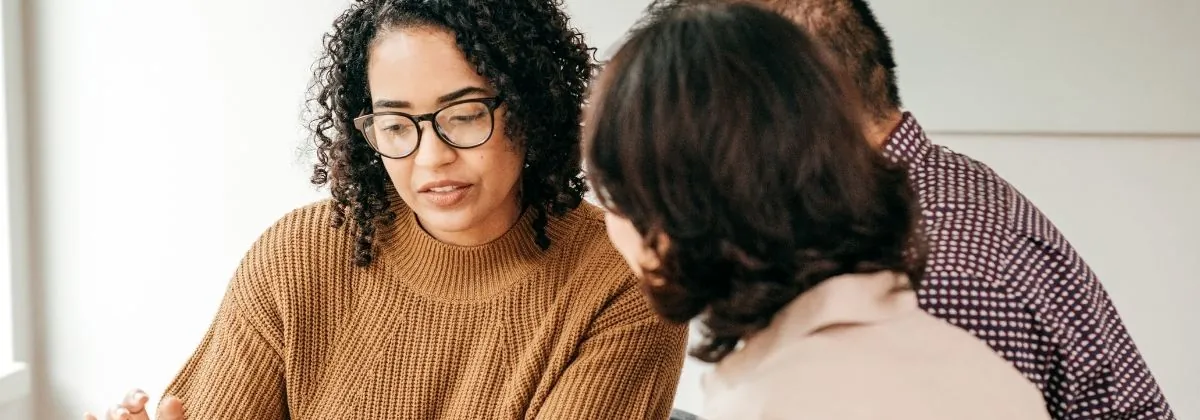 Three colleagues talking something through over a document